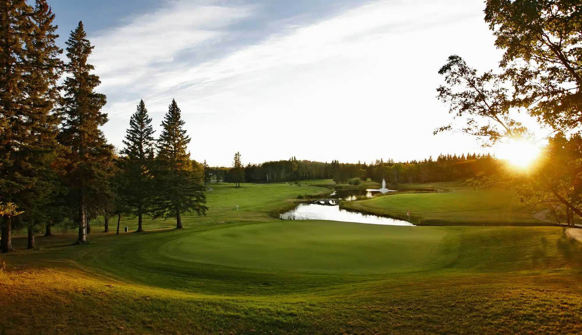 A golf course fairway with a water hazard. inland water golf water hazard.