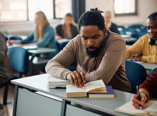 Black Man Studying During Adult Educational Training Course In The Classroom.